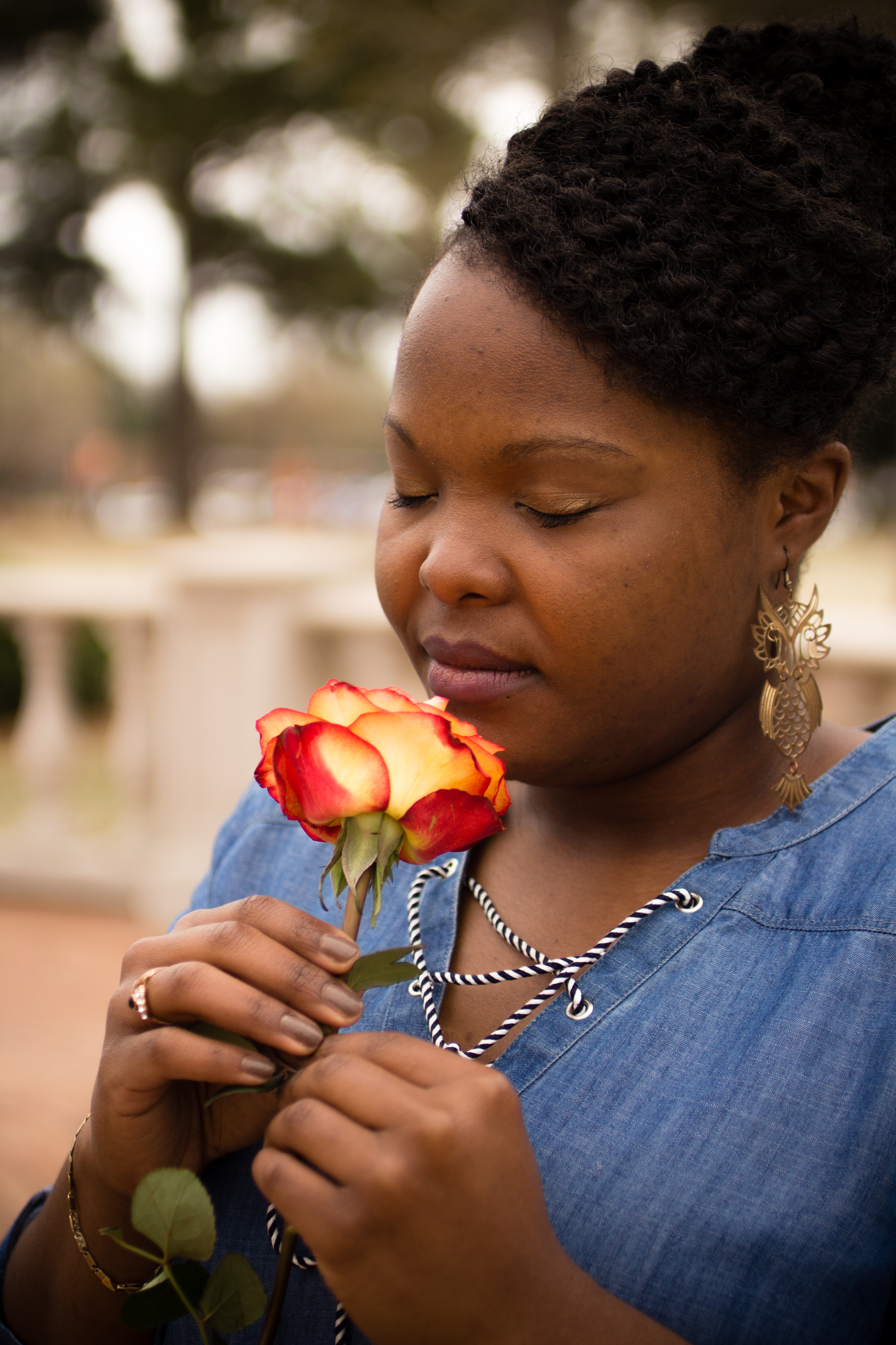 Shaniqua Simuel, Founder, smelling a rose.